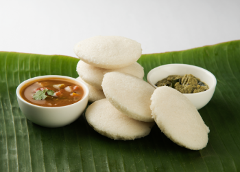 Idli with sambar in a banana leaf