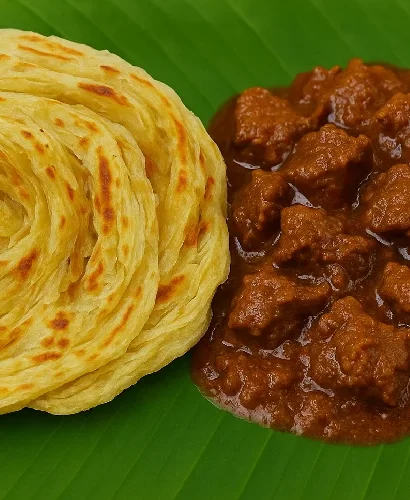 Porotta and Beef Curry in a banana leaf